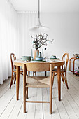 Table set for Easter and bistro chairs in dining room