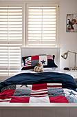 Bed linen with Stars-and-Stripes motif on bed in teenager's bedroom