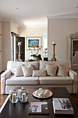 Coffee table and pale sofa with scatter cushions in living room