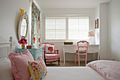 Pink chairs and white desk in girl's bedroom