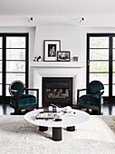 Low coffee table and two chairs in front of the fireplace in the living room