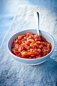Tomato sauce in a bowl with a spoon