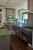 Vintage-style stainless steel kitchen with green and blue accents