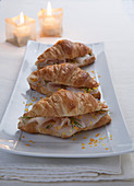 Croissants with smoked fish, orange zest and fennel leaves