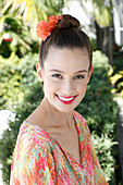 A young woman wearing flowers in her hair