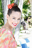 A young woman wearing flowers in her hair