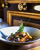 A mushroom dish made with button mushrooms, porcini mushrooms and herbs