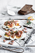 Slices of bread topped with butter, shrimps, eggs and dill