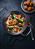 Vegan dumpling dish with bean balls, broccoli, mushrooms and cress