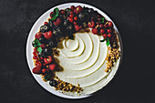 Vanilla sponge cake with berries, gold powder and hazelnut brittle