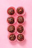 Sugar free, raw, vegan, energy protein balls made with dates, almonds, coconut oil, cocoa nibs and freeze dried strawberries