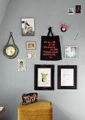 Pictures, photos, cloth bag with message and clock on grey wall