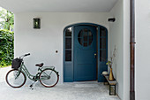Bicycle and half-opened front door in entrance area