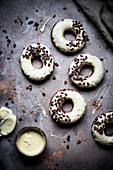 Chocolate Baked Doughnuts Dipped In White Chocolate Decorated With Cacao Nibs