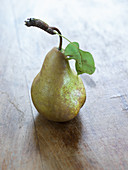A pear with a stem and leaf