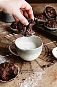 Dunking a chocolate muffin into milk