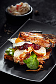 A stollen burger with poultry breast, quail egg and cranberry mustard