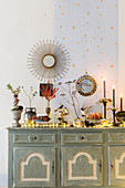 Lavish, vintage-style arrangement of Christmas decorations on sideboard