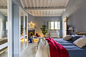 Bedroom with pale blue walls and Christmas decorations in country house