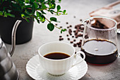 Coffee cup, glass jug, coffee beans and packaging