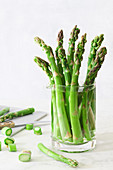 Trimmed asparagus stems in a jug of water