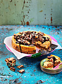 Cheesecake with candy, snickers and chocolate sauce