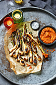 Tender spring onions with charred romesco