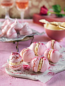 Pink meringues with frosting and raspberry powder for Valentines day