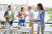 Friends with baby at the summer table