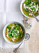 Chicken broth soup with peas