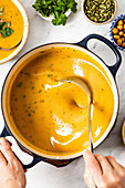 Sweet Potato Soup being served from a pot