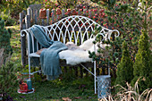 Bench with fur and blanket in the pre-Christmas garden