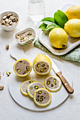 Halved lemons with pistachio and tuna filling