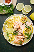Fried salmon with fennel and lemon wedges