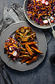Spicy cauliflower 'steak' with red cabbage salad and sweet potato fries