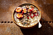 Porridge with plums, pecan nuts and pomegranate