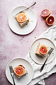 Poppy seed blood orange cake from a tin with icing and slices of orange