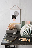 Still-life arrangement on desk: wooden blocks, accordion folder, note book and wooden hand wearing watch
