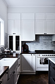 Classic white kitchen with panelled doors and high ceiling