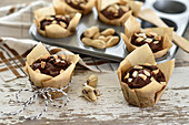 Vegan gluten-free chocolate and peanut muffins in paper cases