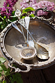 Antique silver cutlery in a silver bowl