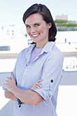 A young woman wearing a purple t-shirt and a striped shirt