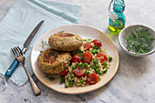 Salmon fritters with pea and cherry tomato risotto, fresh dill, olive oil