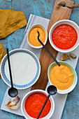 Various sauces in small bowls