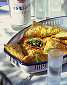 Greek pastries filled with spinach and ouzo