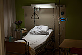 Empty hospital bed at night