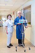 Nurse and patient walking through the hall