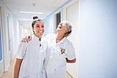 Nurses laughing in corridor