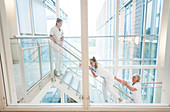 Nurses laughing and sliding down the stairs