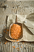 Red lentils in wooden scoop